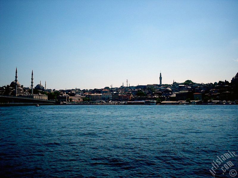 View of Eminonu coast, (from left) Galata Bridge, Yeni Cami (Mosque), Sultan Ahmet Mosque (Blue Mosque), (below) Egyptian Bazaar (Spice Market) and Beyazit Tower from the shore of Karakoy-Persembe Pazari in Istanbul city of Turkey.
